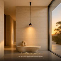 HELVETIOS II encendida sobre tina de piedra en baño con ventanal