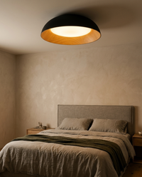 Plafón LEGNO encendido sobre cama matrimonial con cabecera de lino en recámara de estilo natural